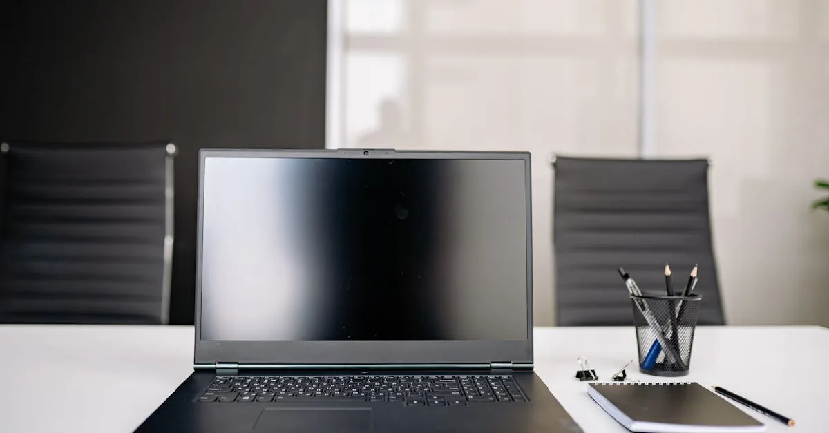 A sleek workspace featuring a laptop on a gray table with a leather chair, creating a minimalist office vibe.