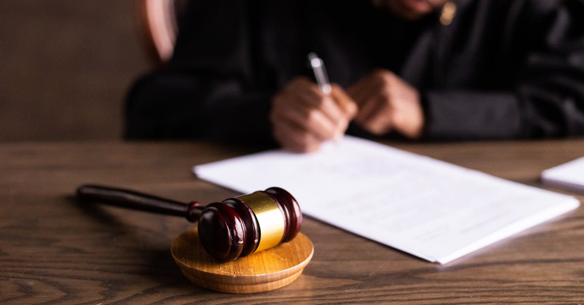 Close-up of a wooden judge's gavel on a black desk, symbolizing justice and law.